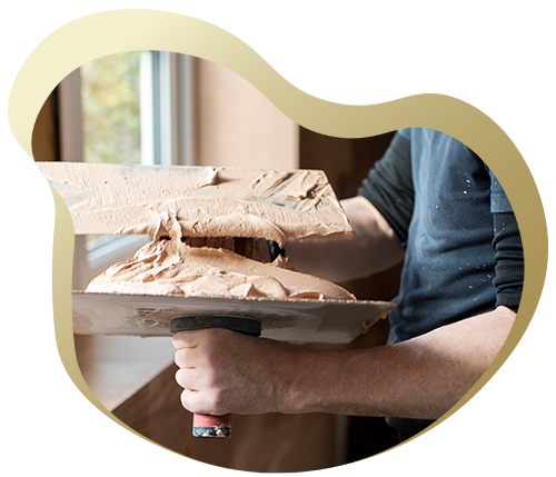 person applying plaster with a trowel two layers of texture in a room renovation