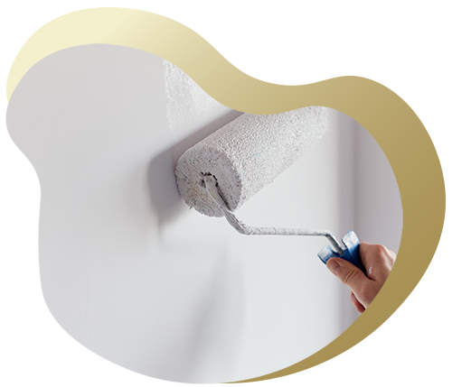 a person holding a paint roller applying white paint to a wall interior painting project tips for two coats