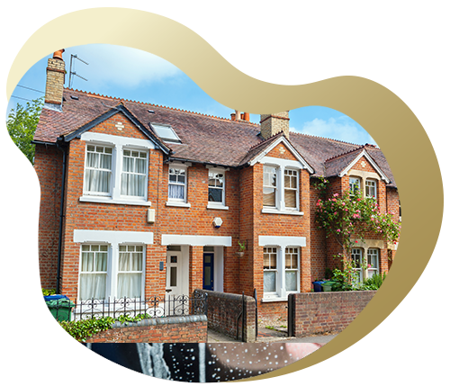 A row of charming brick townhouses with white trim and flowered gardens, showcasing a beautiful residential neighborhood.