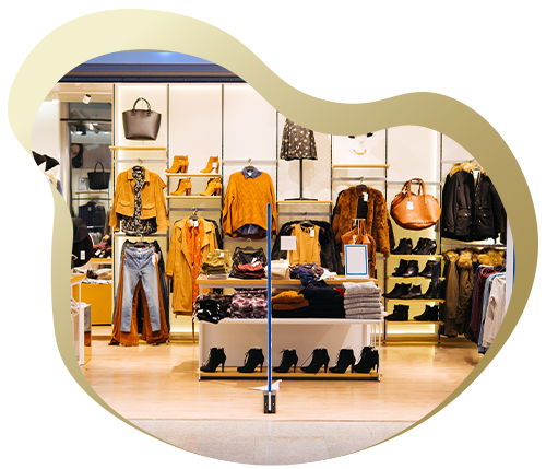 A stylish clothing store display featuring trendy garments, accessories, and footwear arranged attractively on racks and shelves.