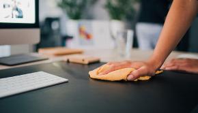 hand cleaning desk with cloth